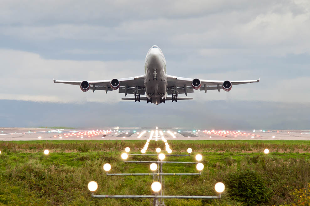Airplane taking off from Manchester Airport Plane taking off from Manchester Airport with landing lights