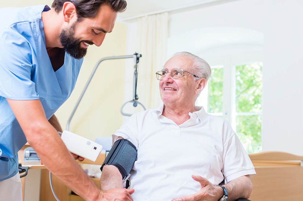 Carer Home male nurse assisting senior man